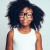 Cute youing African girl wearing glasses against a gray backgrou